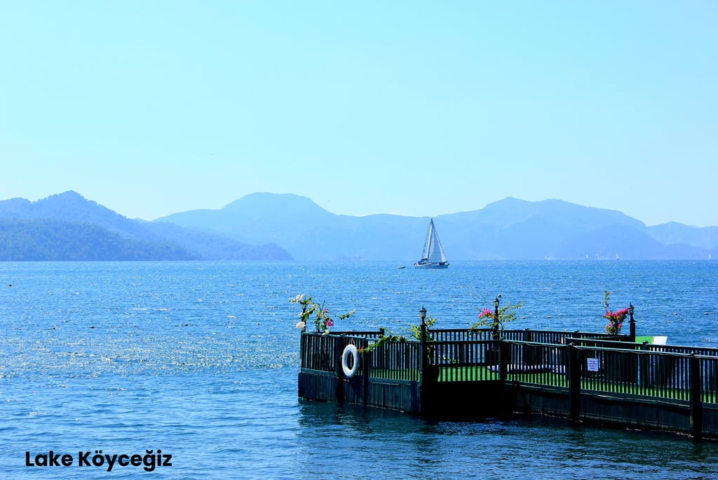 a sailboat is docked at a pier in Lake Köyceğiz, one of the best places to visit in Dalyan