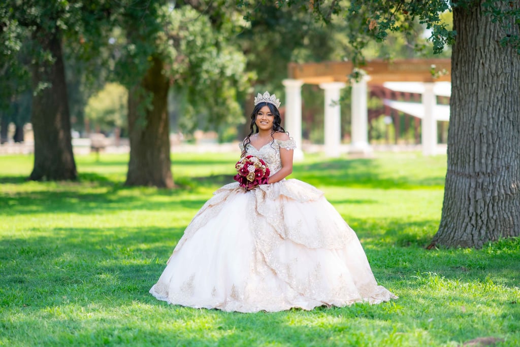 Professional Quinceañera photography in Visalia featuring a girl in a white and gold gown.
