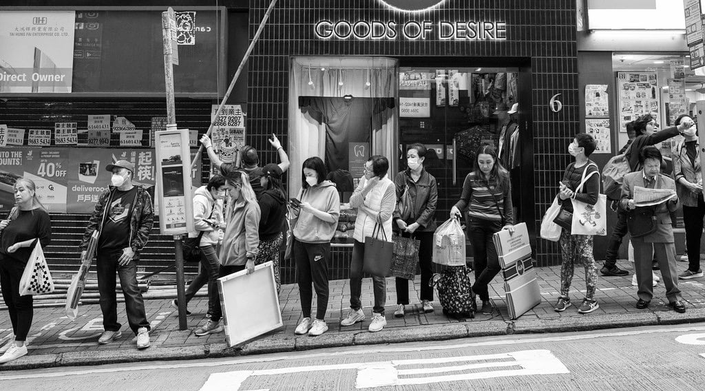 People queue up for a bus in Hong Kong