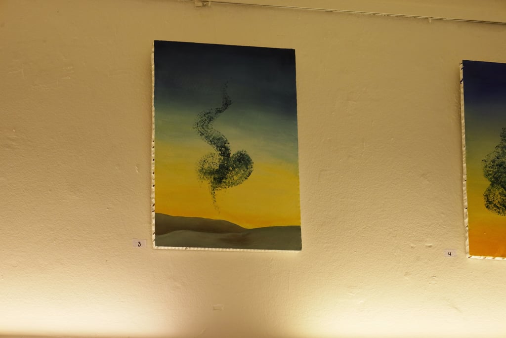 Abstract oil painting of a swirling green form over a desert sunset landscape on a gallery wall.
