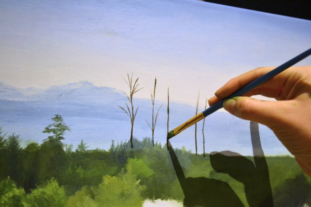 painting branches of trees against mountains
