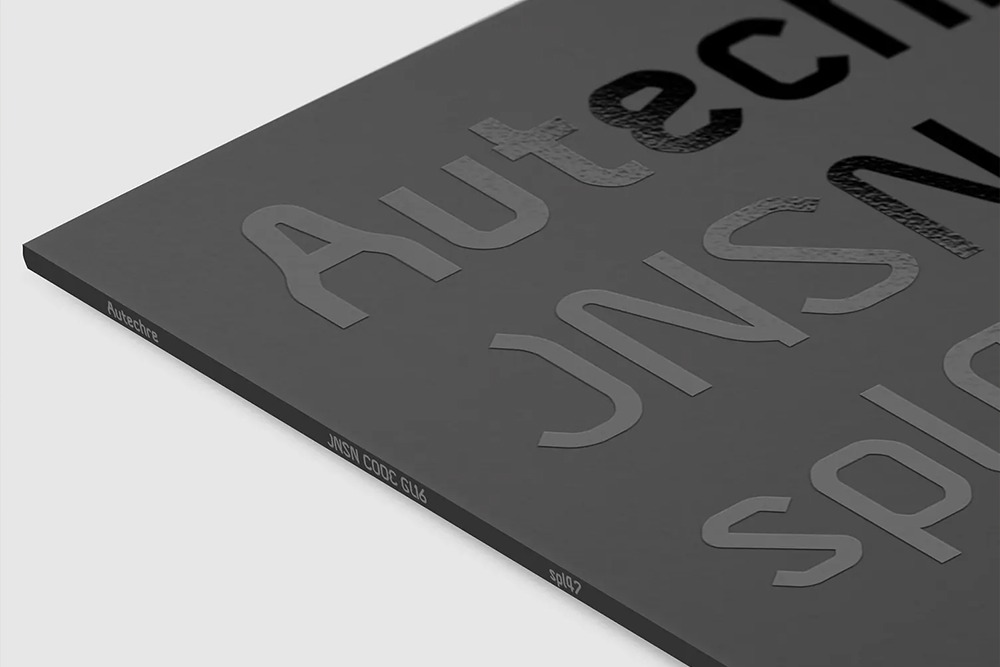 Minimalist black vinyl record sleeve featuring embossed Autechre JNSN CODE GL16 text.