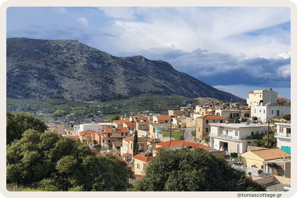 View of Archanes village with green landscapes, traditional old houses, and surrounding mountains