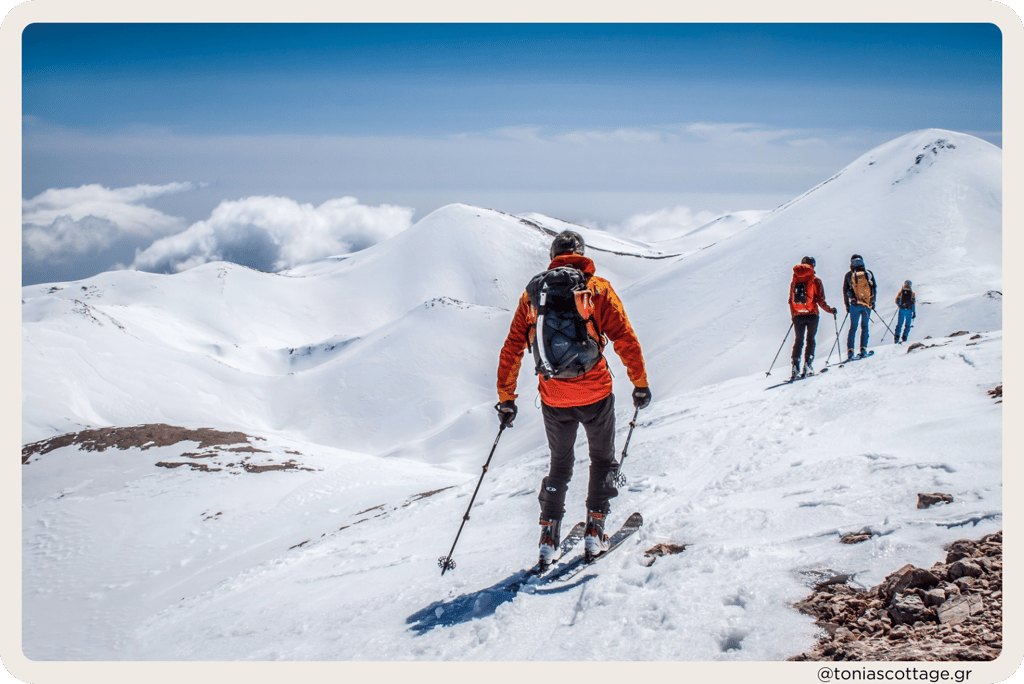 kiers on snow-covered mountains in Crete with clear skies and sunny weather