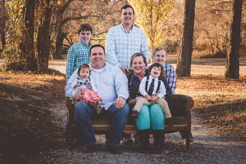 Foster Family sitting on a couch outside