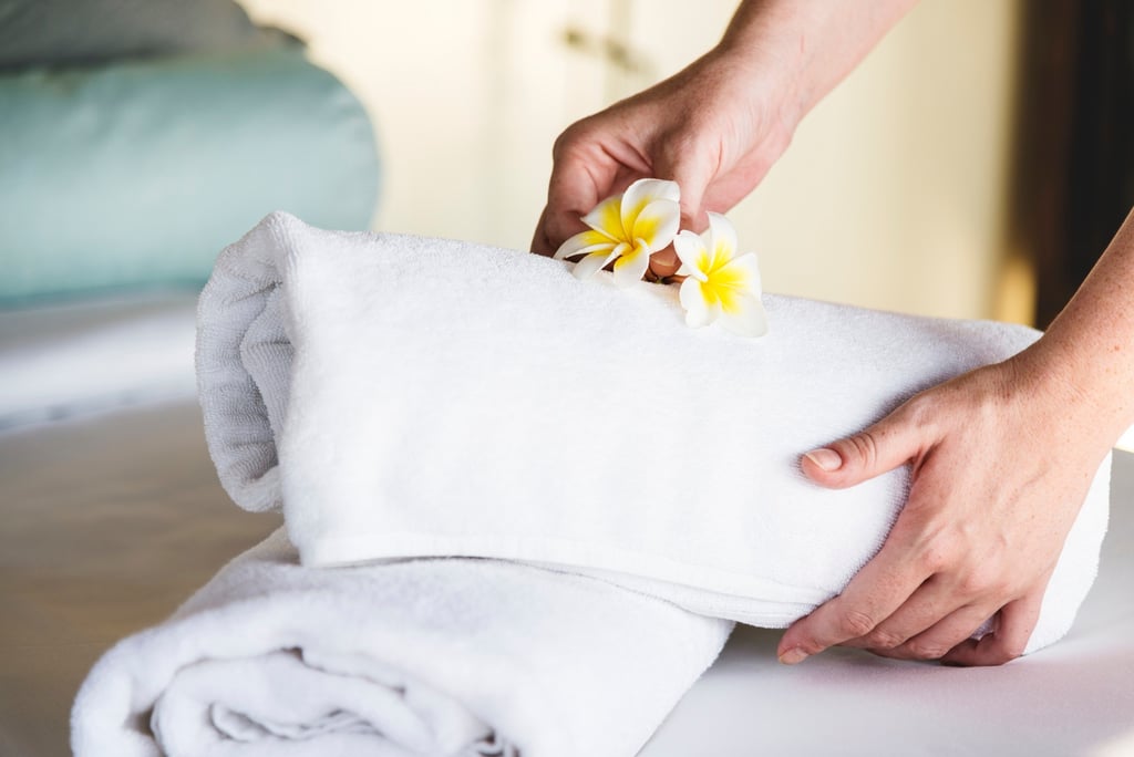 a person holding a towel over a towel