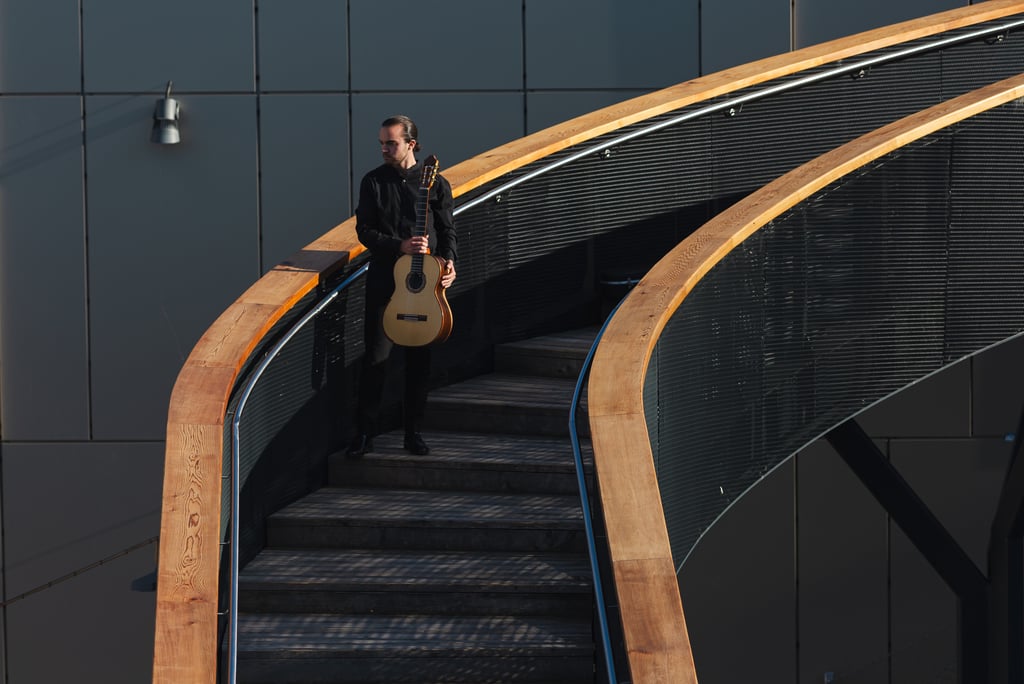 Classical Guitarist Filip Babic standing on stairs outside
