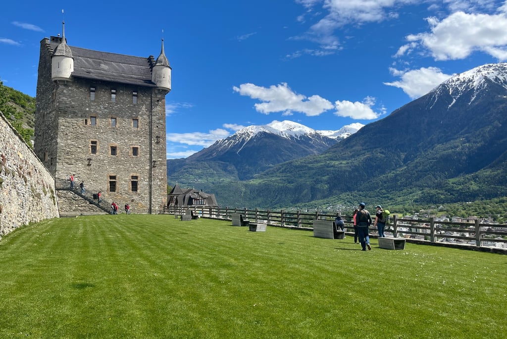 The Courtyard of Schloss Leuk with the town hall in the foreground and the Alps in the backgroudn