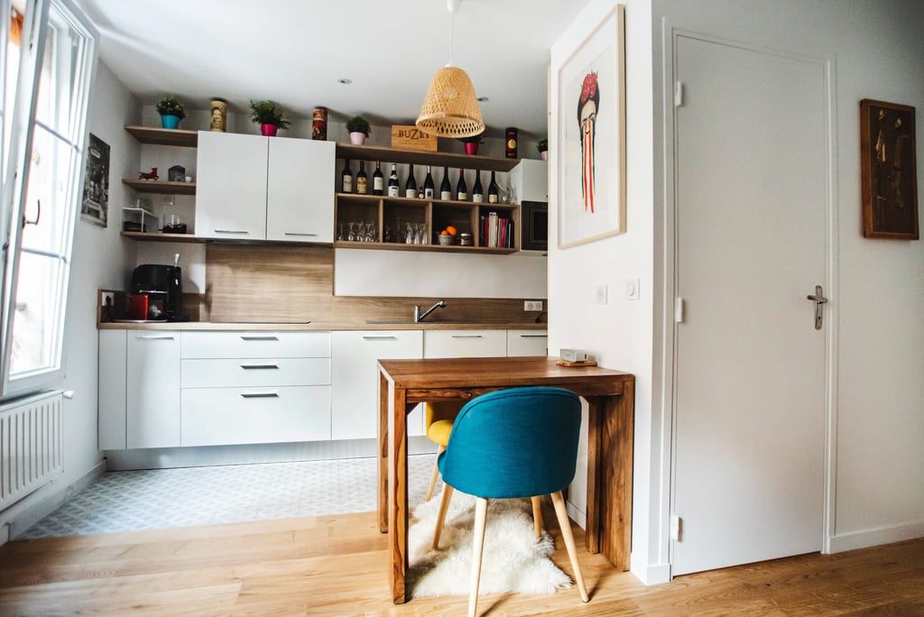 a kitchen with a table and chairs in the middle of the room