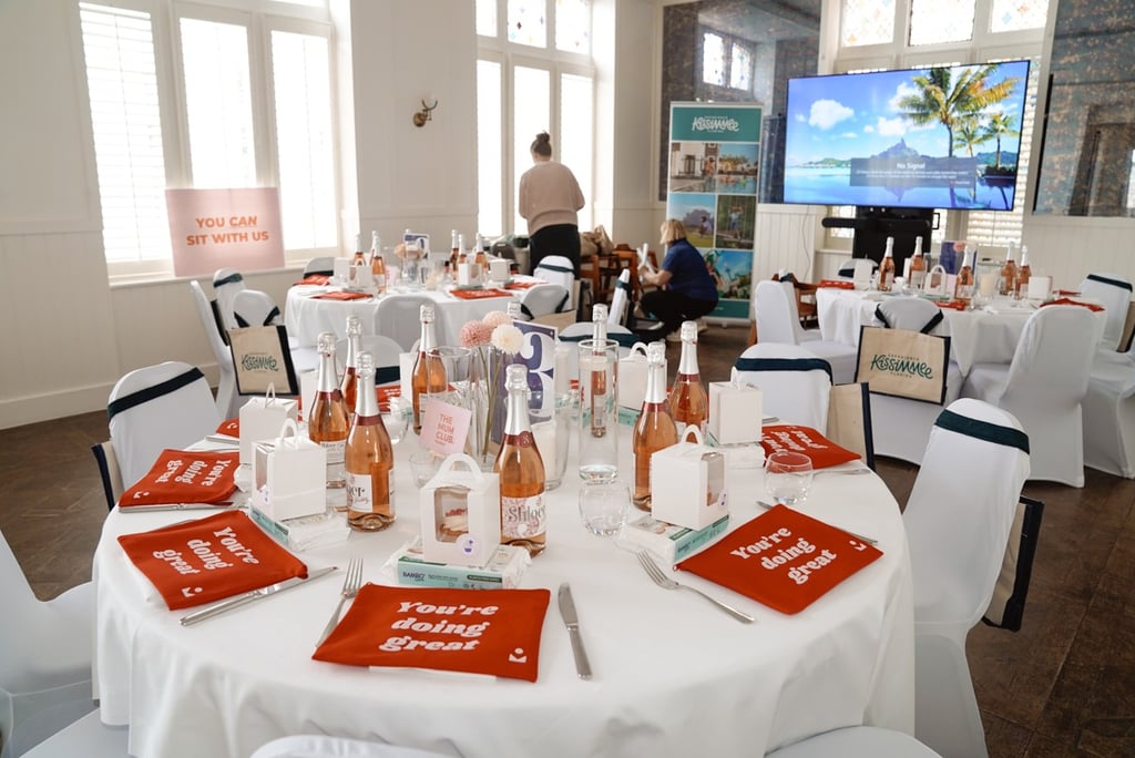event set up with champagne on the table and gift bags