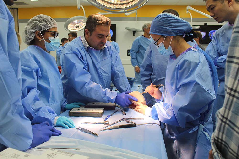 A surgeon teaches students surgery technique