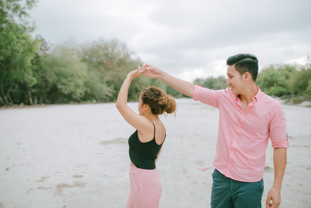 Playful couple twirling on the beach during an intimate session in Serangan Benoa Bali.