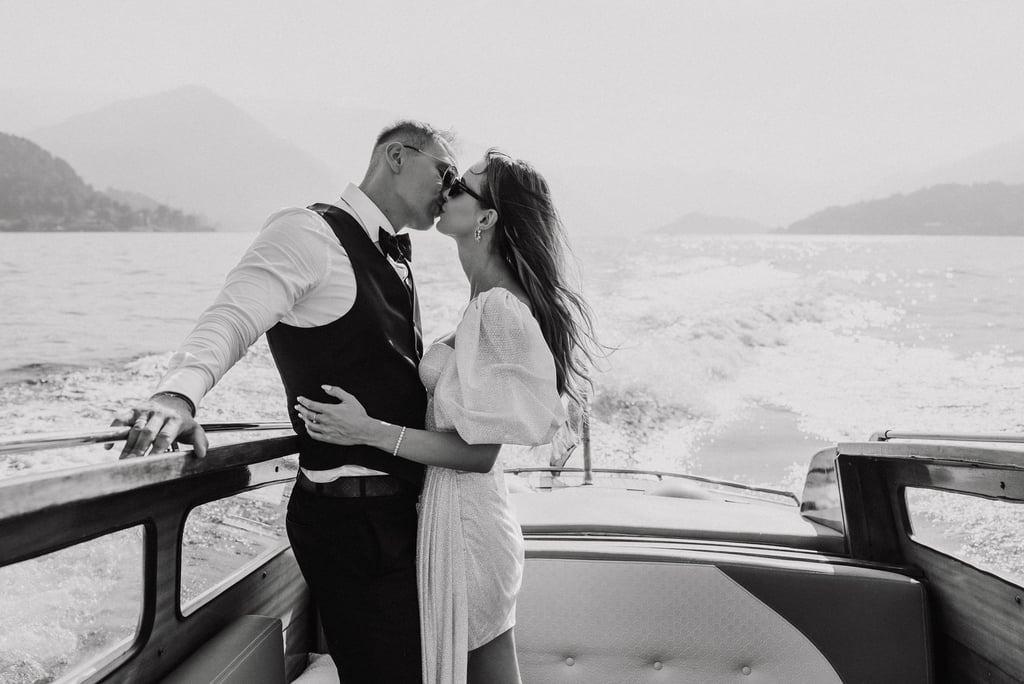 a man and woman kissing on a boat