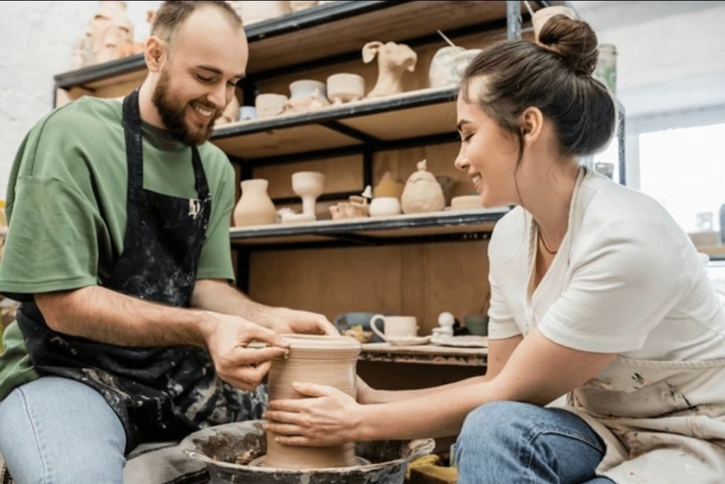 date night pottery fun, a couple making pottery