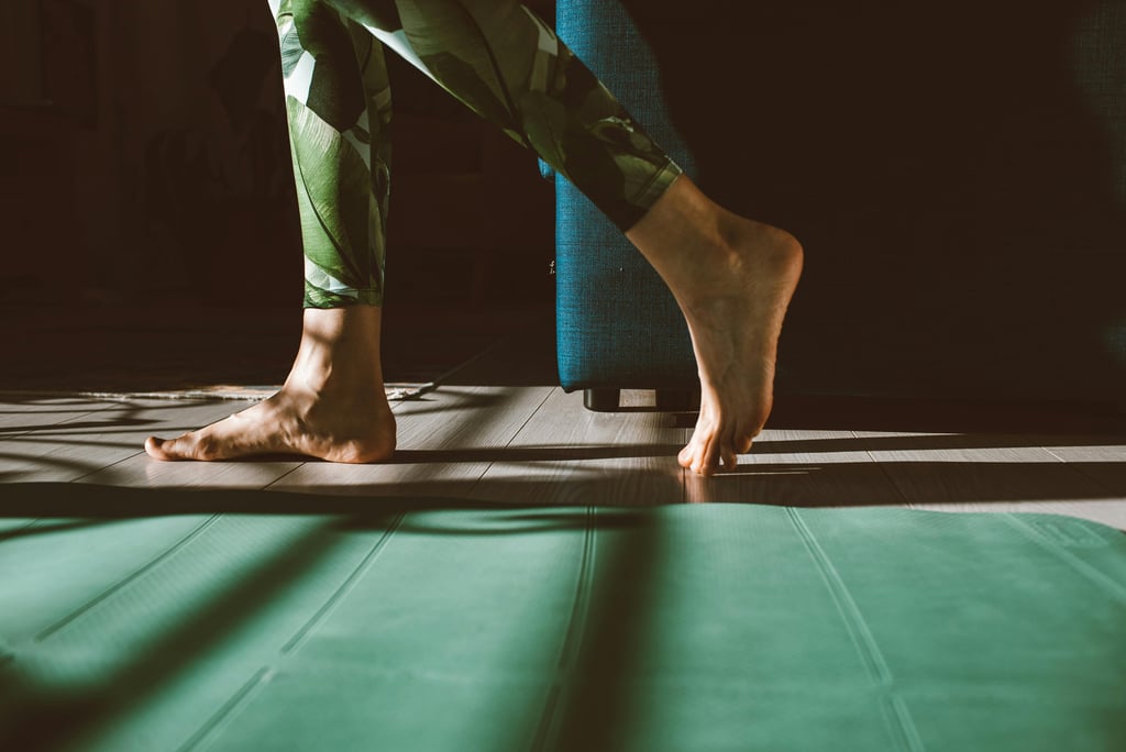 a person standing on a mat with their feet on a mat