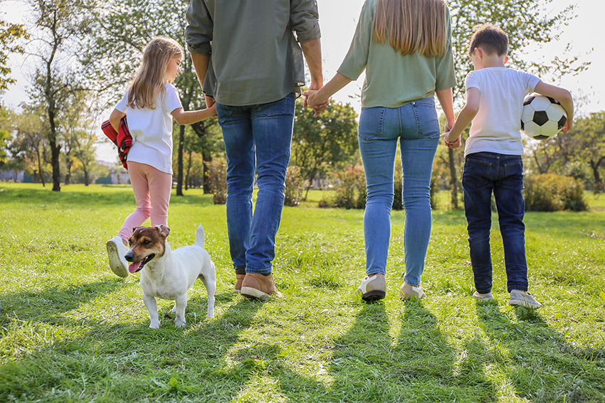 a family of three children playing soccer in a field
