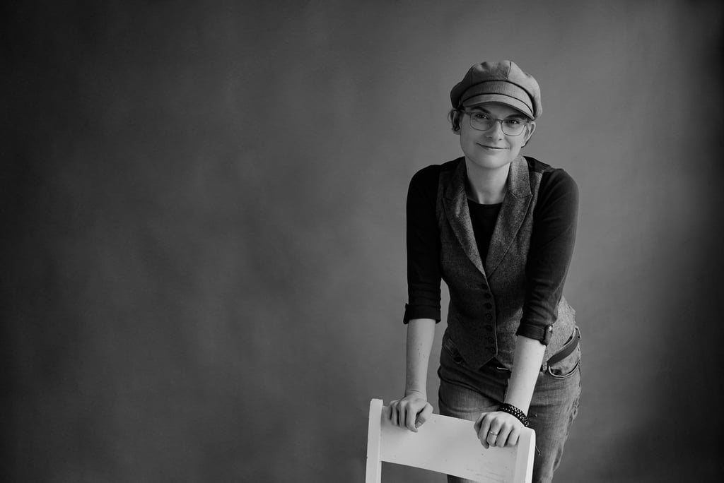 Woman leaning on a chair for a portrait.