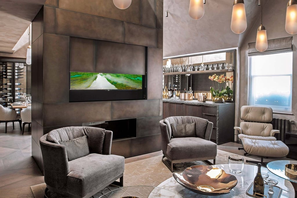 Automated motorised TV lift integrated into a bespoke bedroom cabinet.