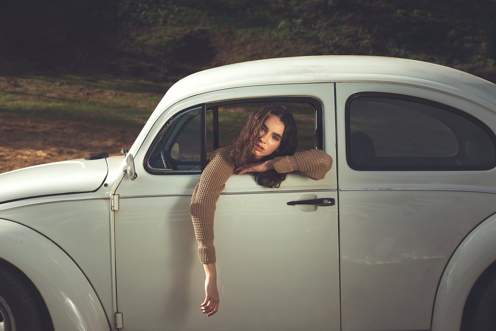 a woman leaning out of a car window
