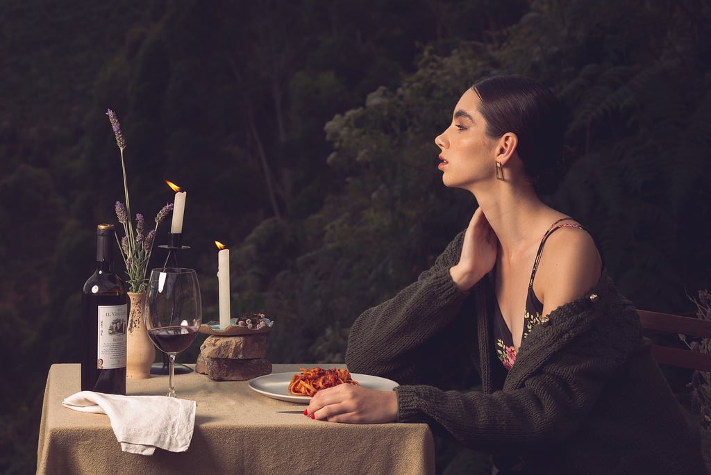 a woman sitting at a table with a plate of food