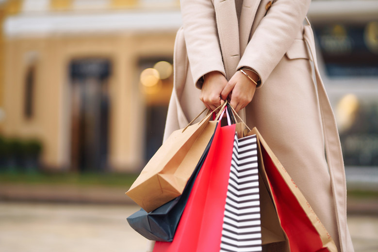 a woman holding shopping bags in her hand