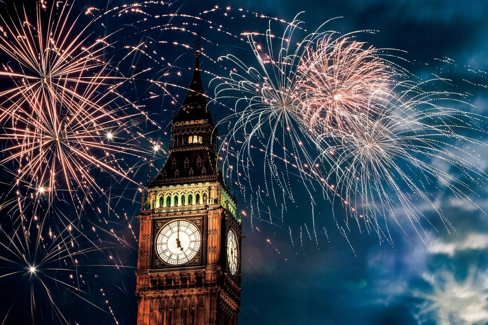 a clock tower with fireworks in the sky london