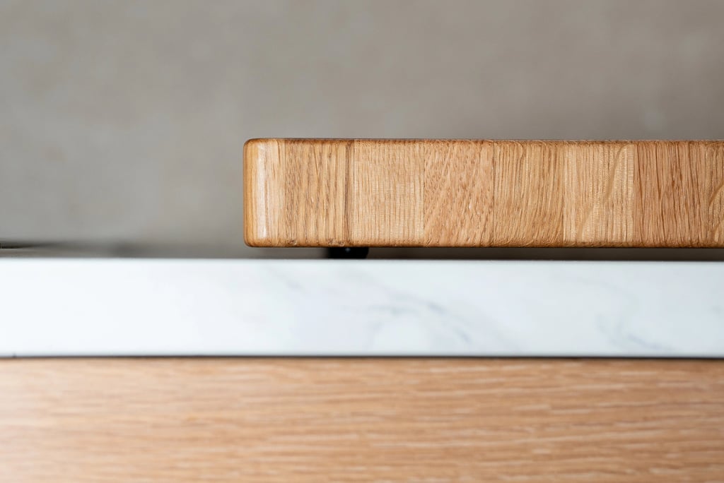 Close-up side view showing the thickness and rounded corner of a wooden chopping board