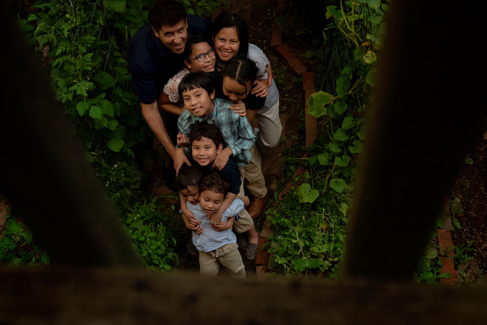 All eight members of the Schauder family posing in their garden. 