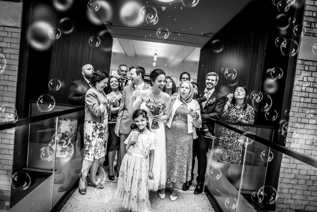 Ben and Patricia with bubbles on the internal bridge at Lambeth Town Hall