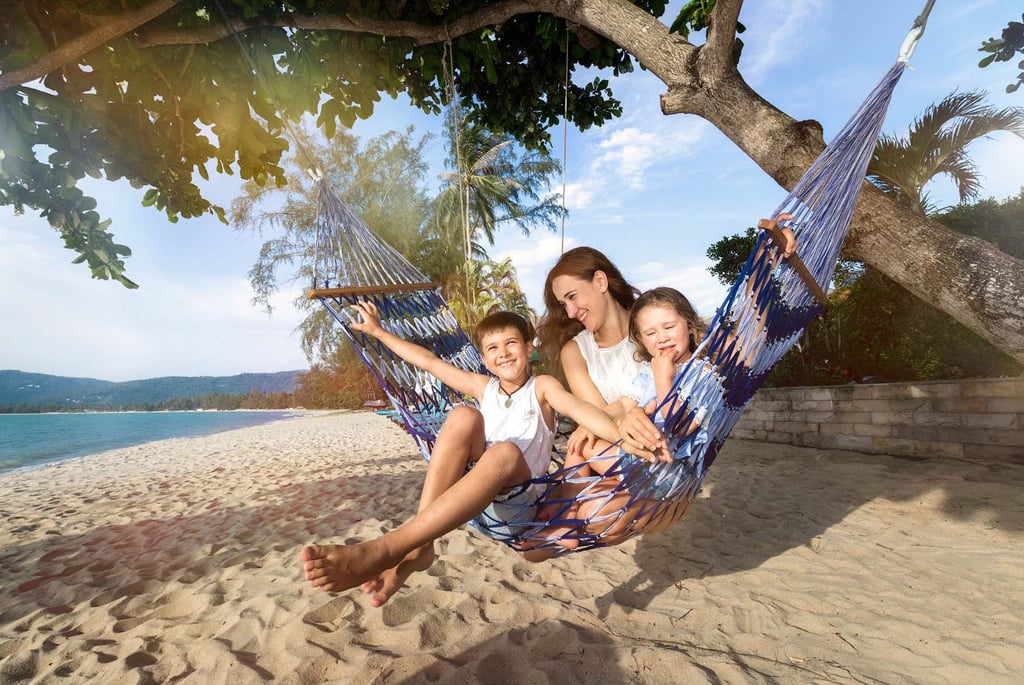 Family relaxing on hammock beach during Koh Samui photoshoot