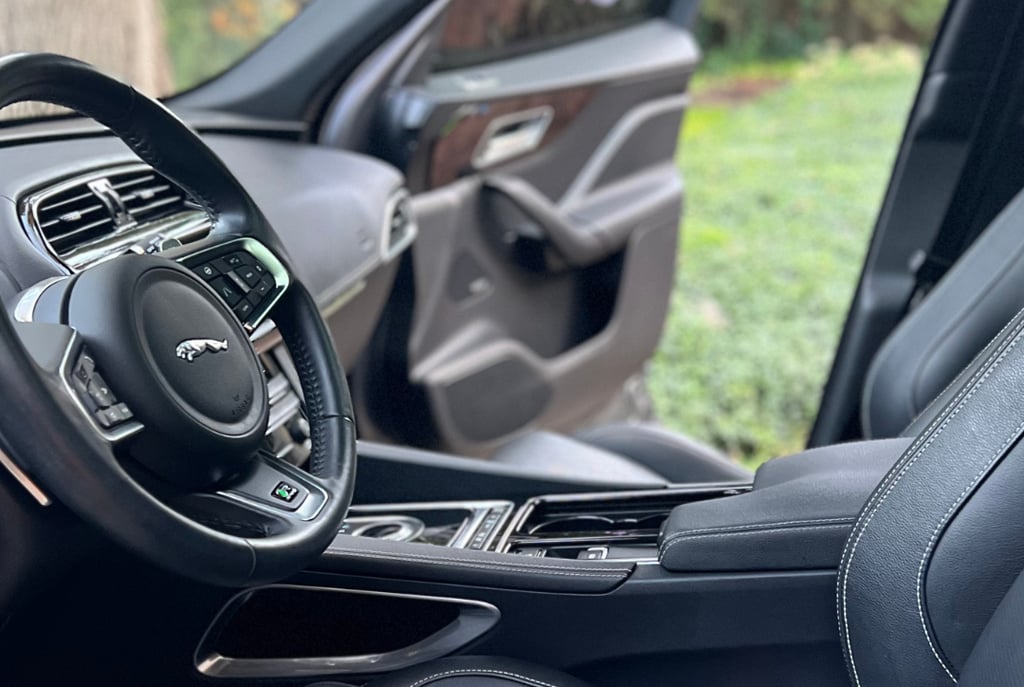 Sanitized SUV interior with clean cupholders and debris-free console