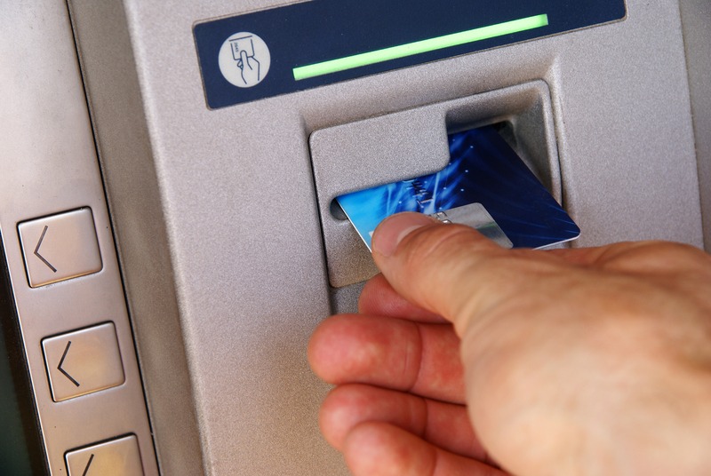Person withdrawing money from an ATM in the Dominican Republic