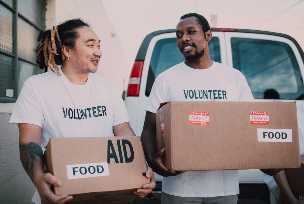 two men in white shirts are holding boxes with boxes