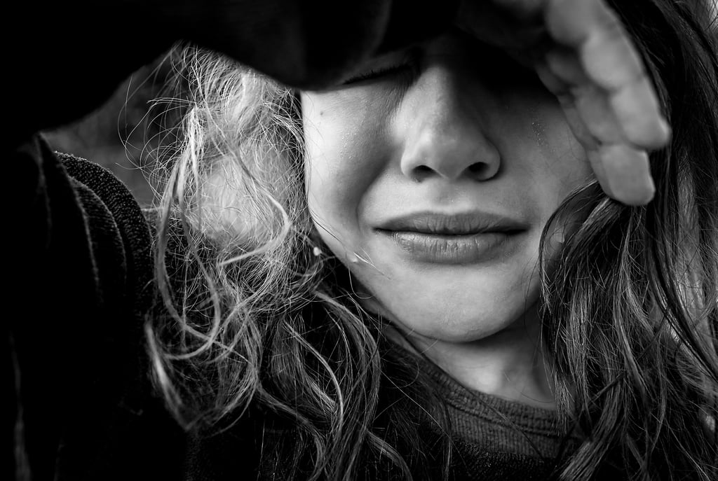 a kid with long hair snd tears and a black and white photo
