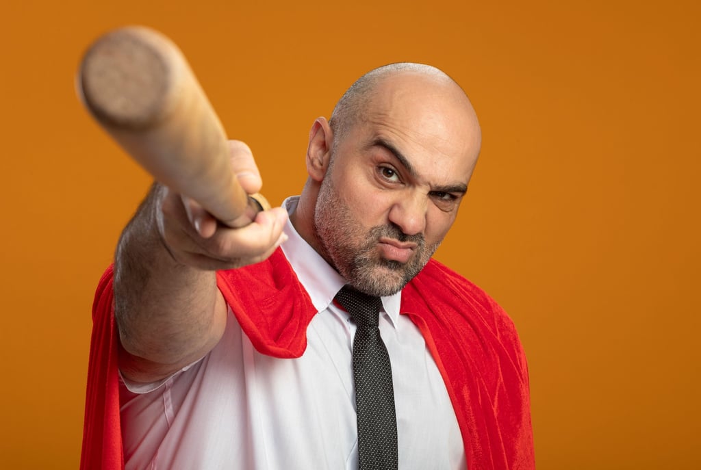 a man in a red cape capelet and a baseball bat