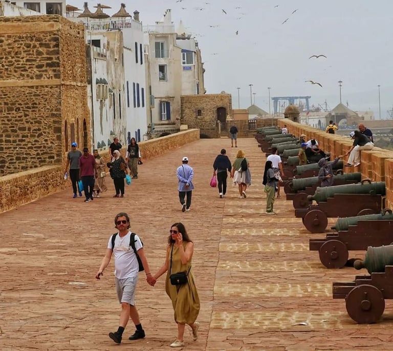 morocco a couple holding hands while walking down a path