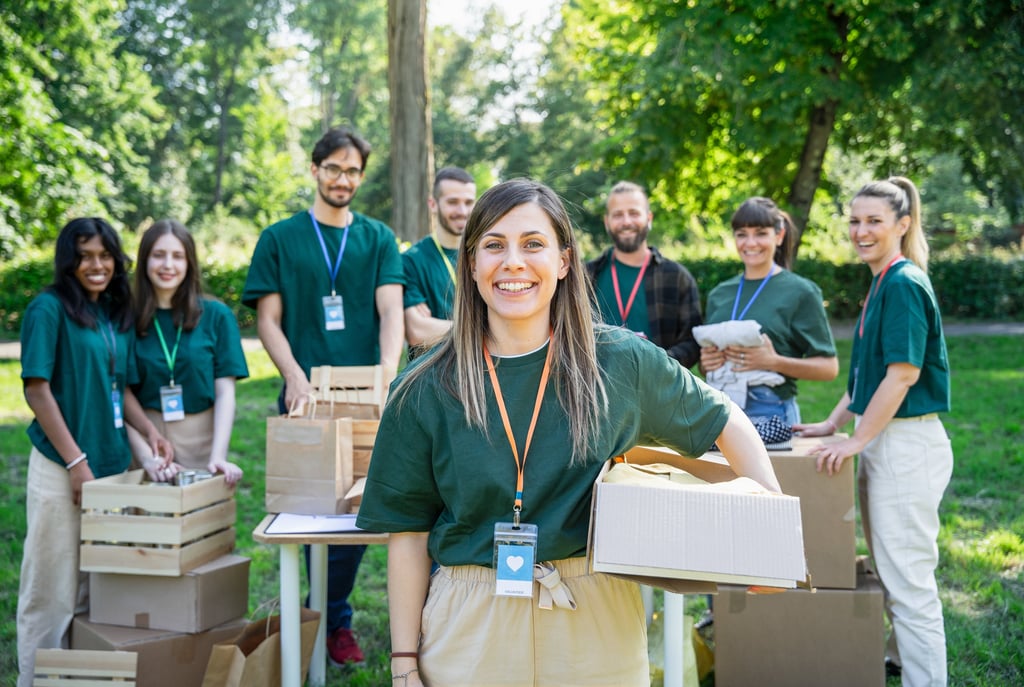Group of volunteers outdoors organizing and packing donation boxes