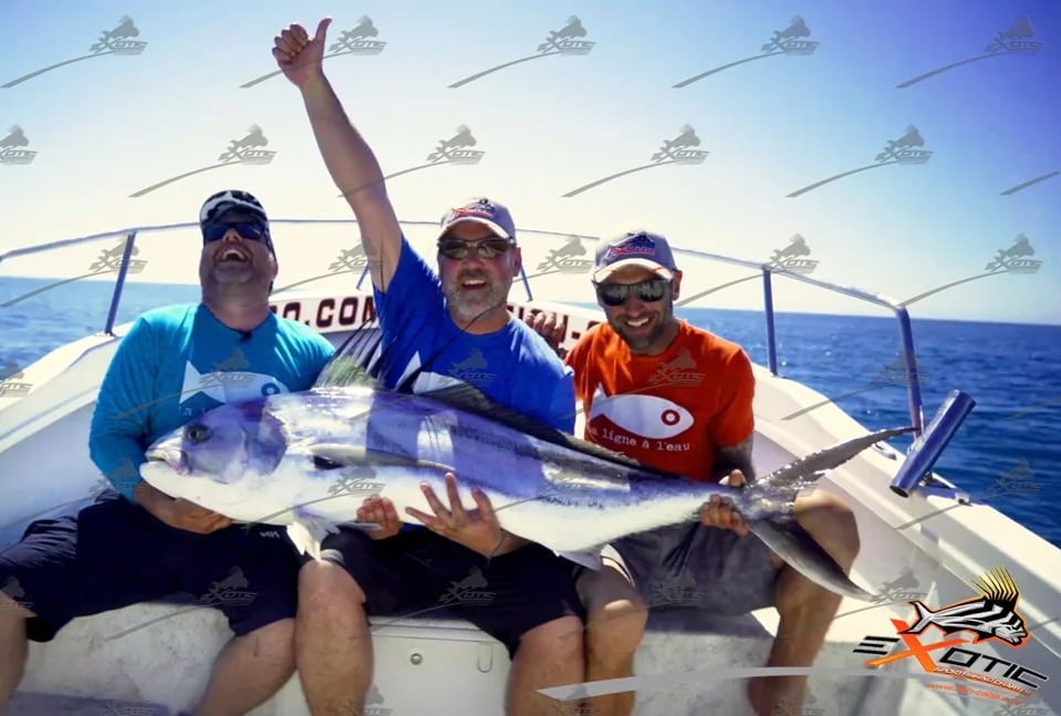 a group of men holding a fish on a boat