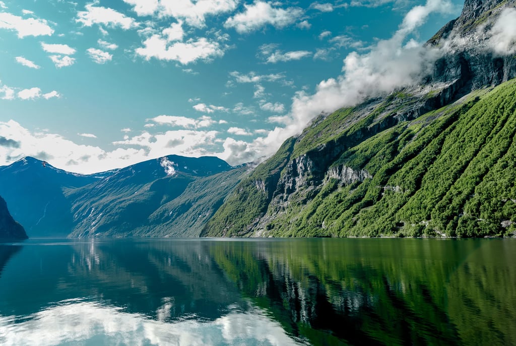 a mountain scene with a lake and mountains in the background