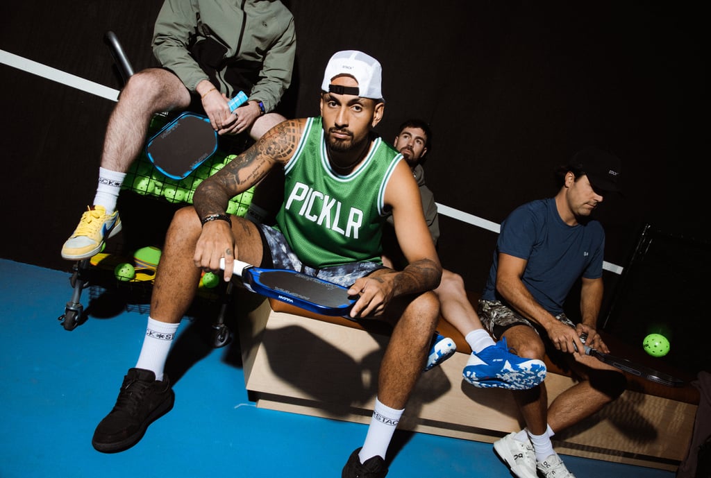 Professional pickleball players posing on a court with Picklr jerseys and paddles.