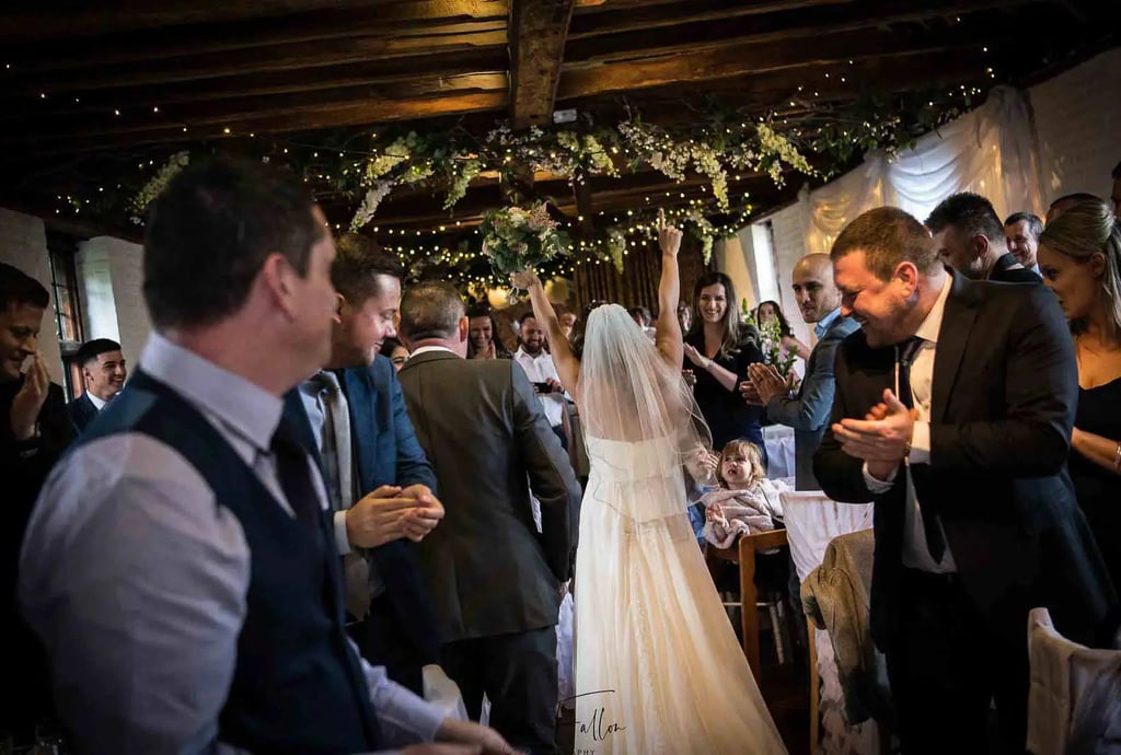 bride and groom entering their evening celebrations at Tudor Barn Eltham