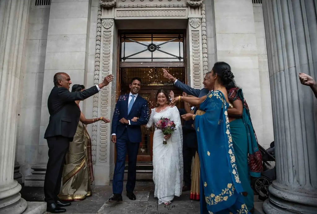 newly-weds being showered with confetti on old marylebone town hall steps