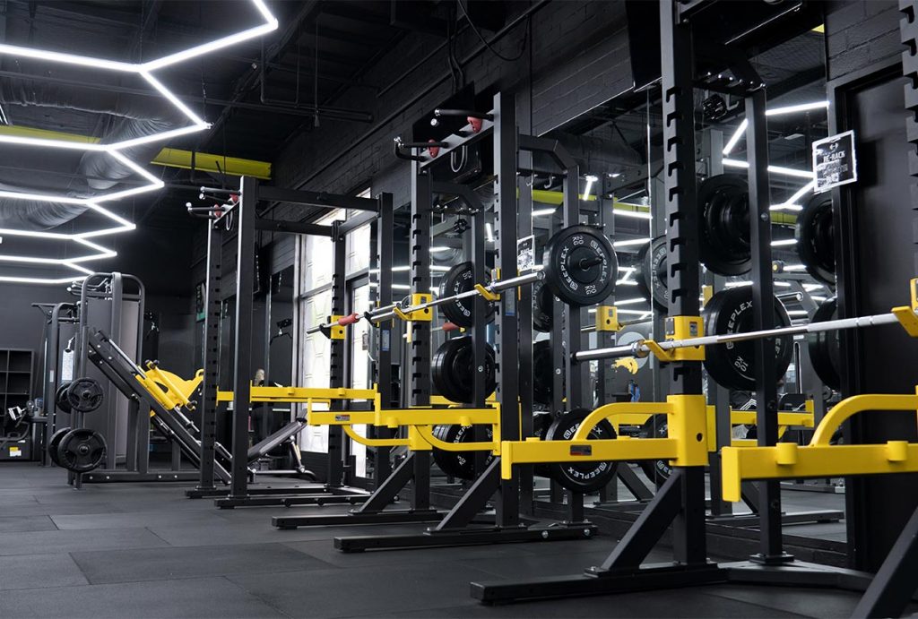 a gym with a lot of equipment and a lot of equipment