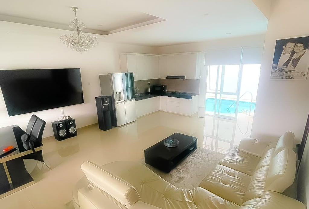 Living room with sofa opening to private pool at Villa Sattara Seminyak, villa for sale Seminyak