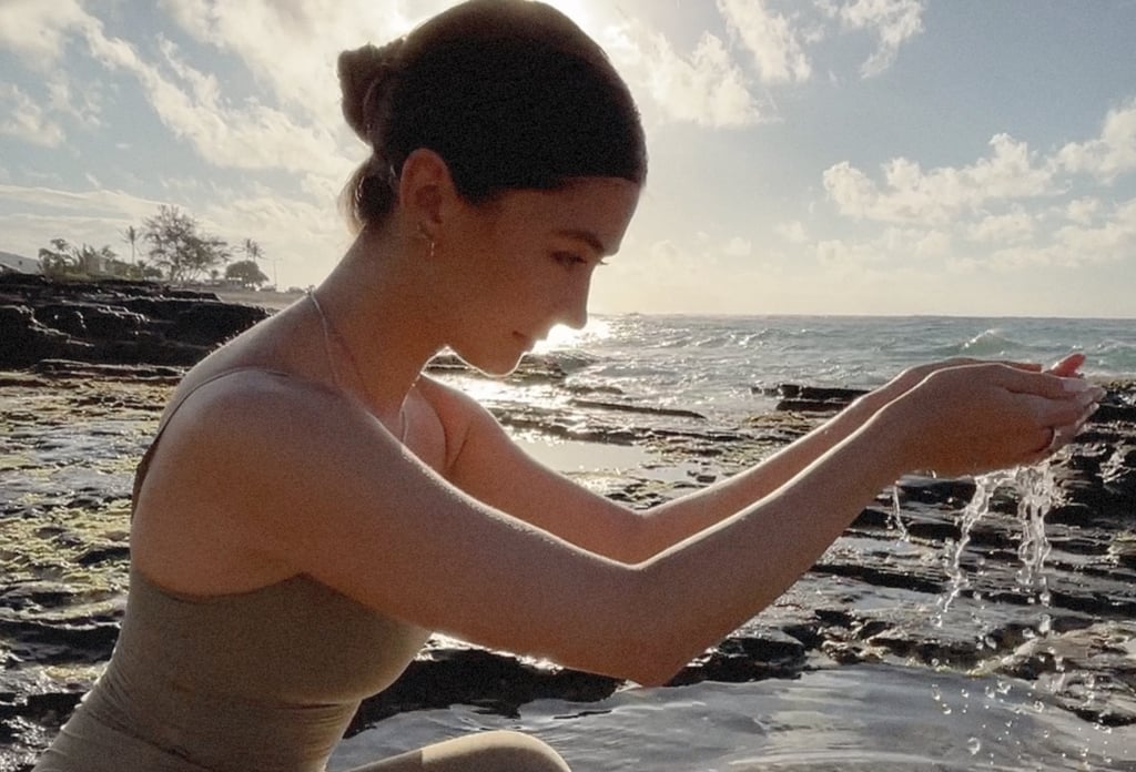 Girl at beach holding water