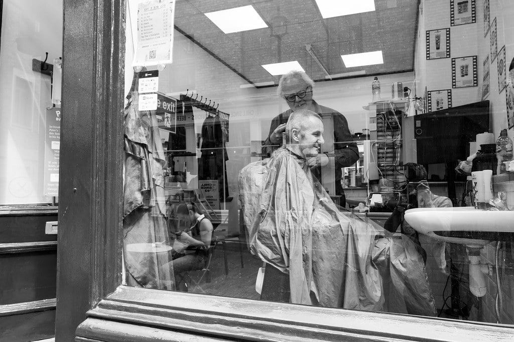 Man having his haircut at a barber shop in London