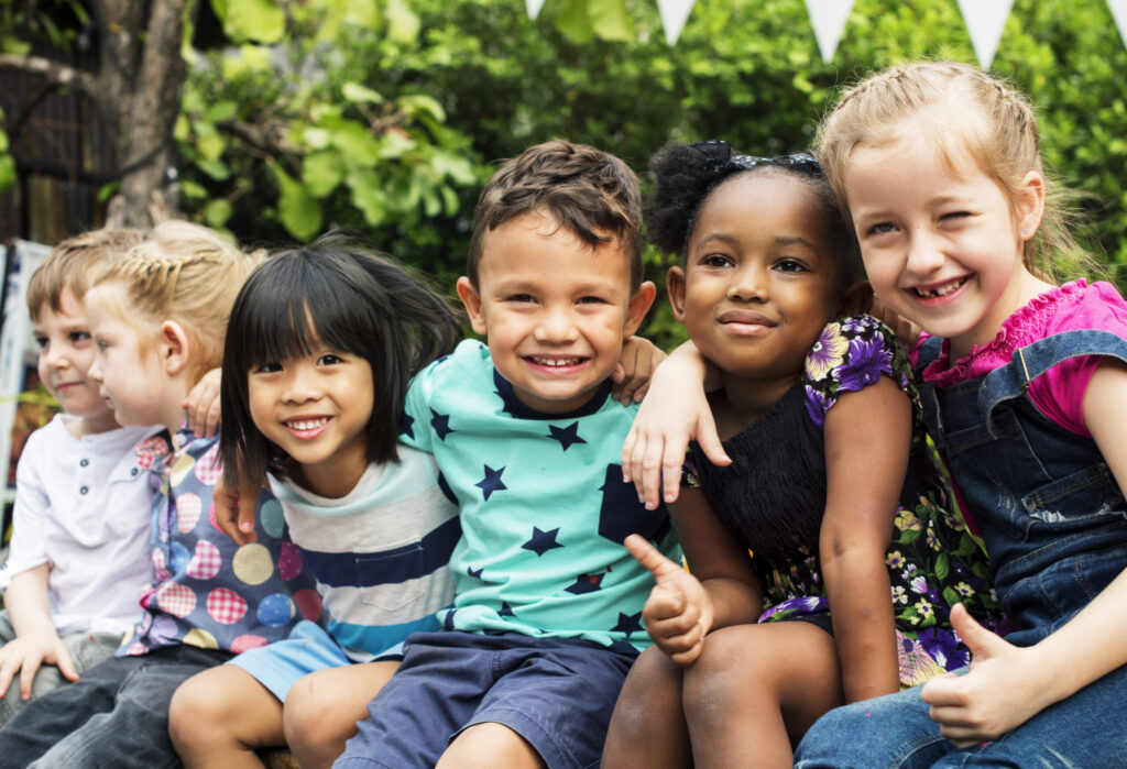 a group of children sitting on a bench