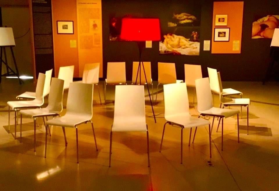 a circle of chairs with chairs and lamps