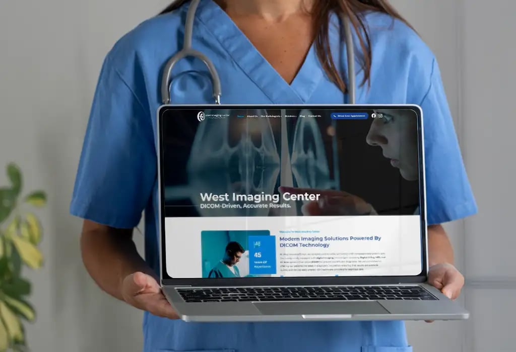 a woman in scrubs holding a laptop computer