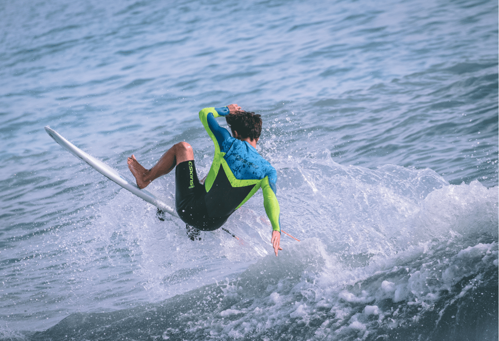 a man in a wetsuit surfing on a surfboard
